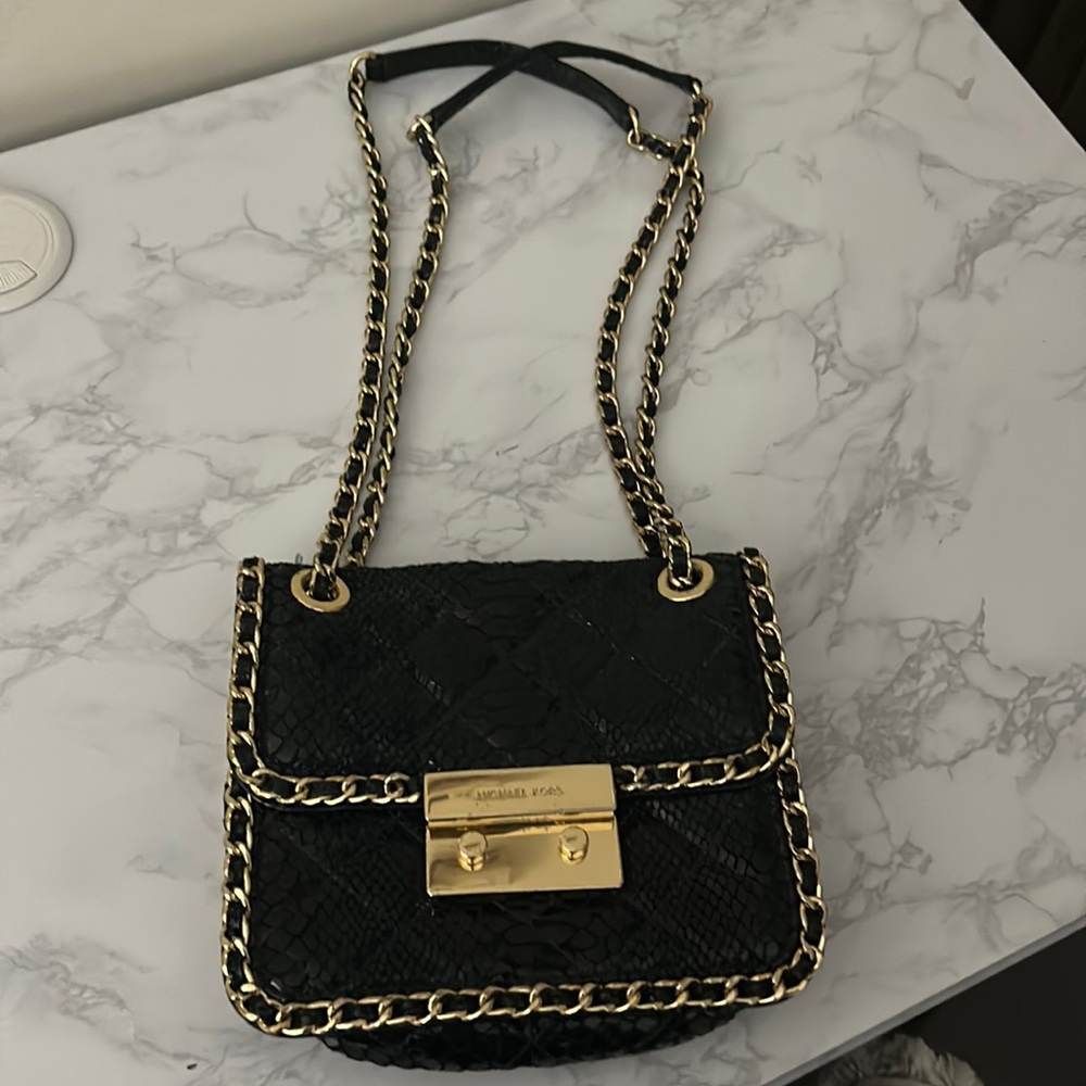 Michael Kors evening bag with black sequence and gold and black chain details.